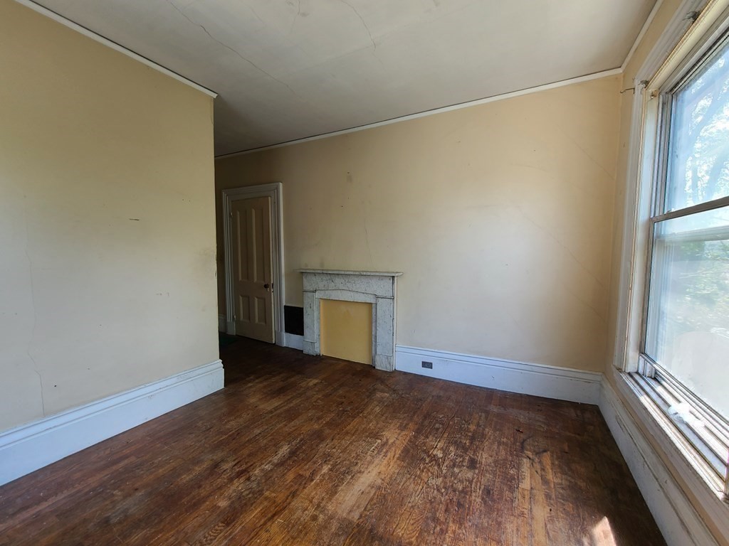 16 Malbert Road Boston, MA 02135 - Photo 23 of 38 an empty room with wooden floor and windows