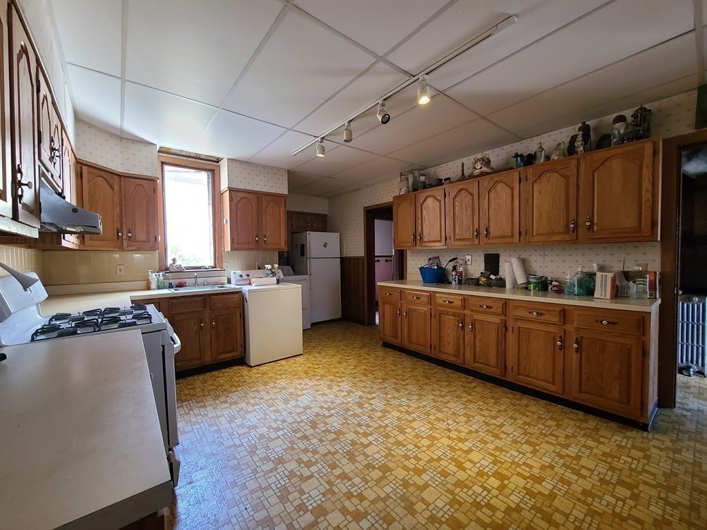 16 Malbert Road Boston, MA 02135 - Photo 5 of 38 a kitchen with granite countertop a sink cabinets and stainless steel appliances