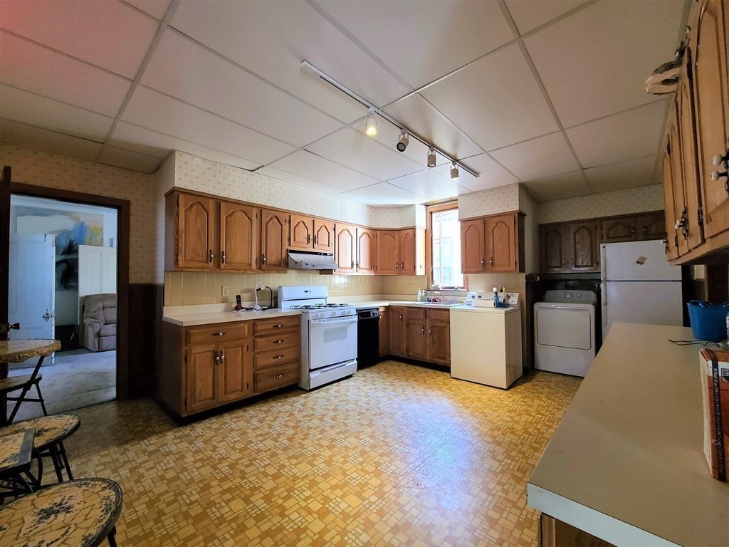 16 Malbert Road Boston, MA 02135 - Photo 6 of 38 a large kitchen with a large counter top appliances and cabinets
