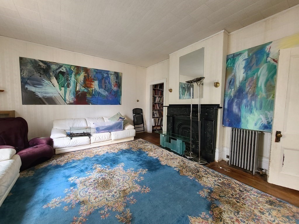 16 Malbert Road Boston, MA 02135 - Photo 8 of 38 a living room with furniture and a fireplace