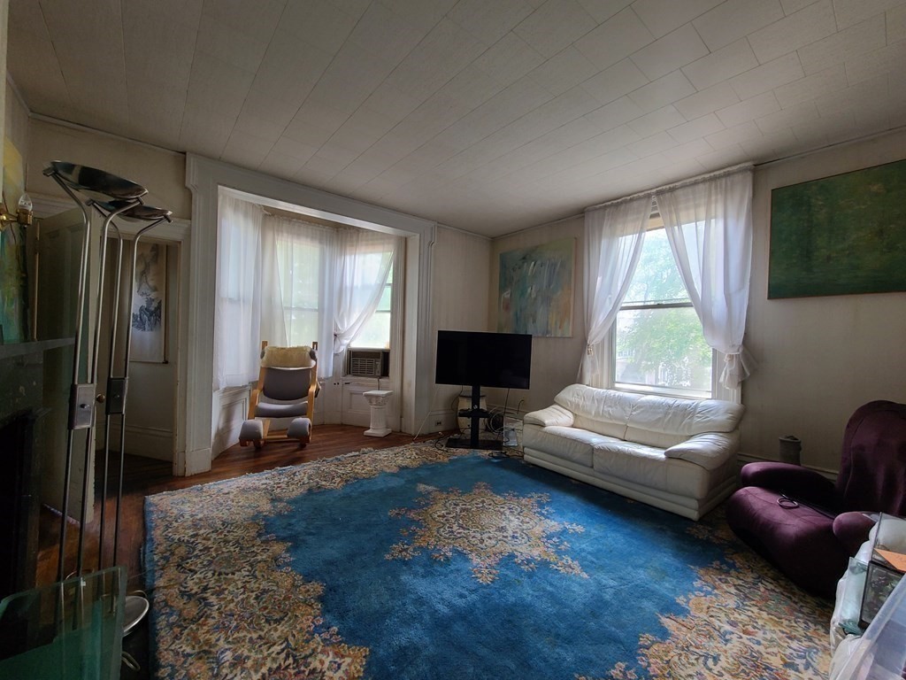 16 Malbert Road Boston, MA 02135 - Photo 9 of 38 a living room with furniture and a window