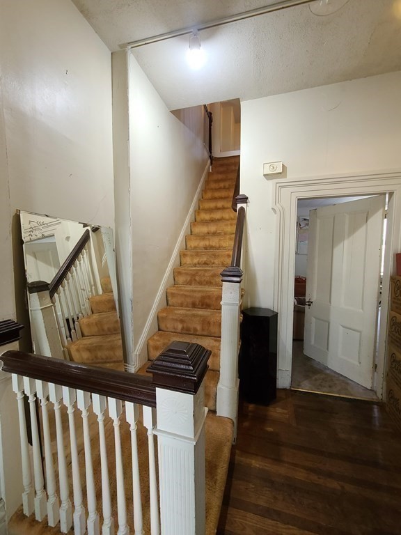 16 Malbert Road Boston, MA 02135 - Photo 10 of 38 a view of a hallway with wooden floor and staircase