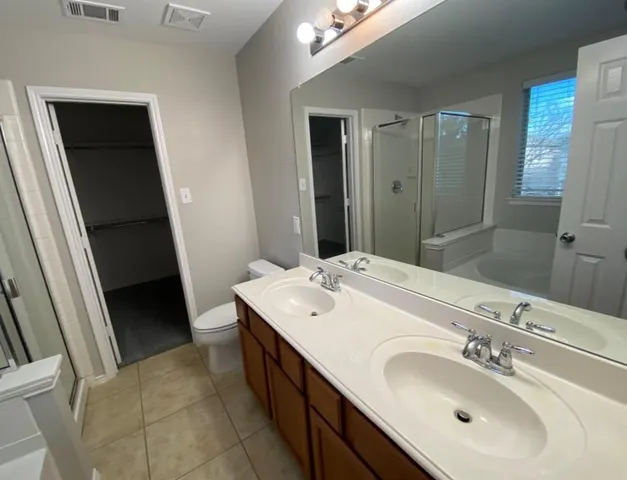 a bathroom with a double vanity sink and mirror