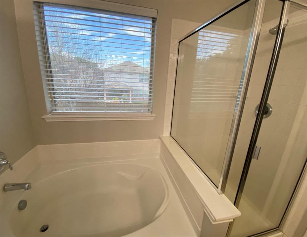 10608 Colfax Drive McKinney, TX 75072 - Photo 20 of 21 a bathroom with bathtub and shower