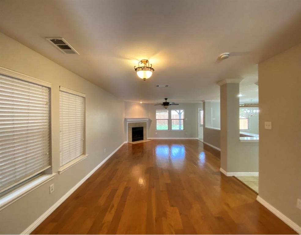 10608 Colfax Drive McKinney, TX 75072 - Photo 3 of 21 a view of empty room with window and wooden floor
