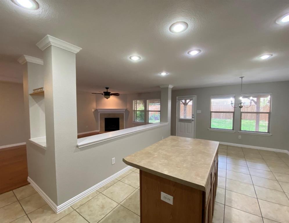 10608 Colfax Drive McKinney, TX 75072 - Photo 8 of 21 a kitchen with kitchen island a sink stainless steel appliances and window
