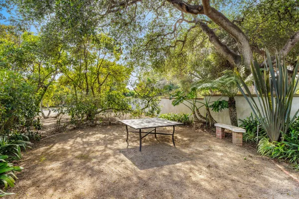 a view of backyard with a small cabin and wooden chair
