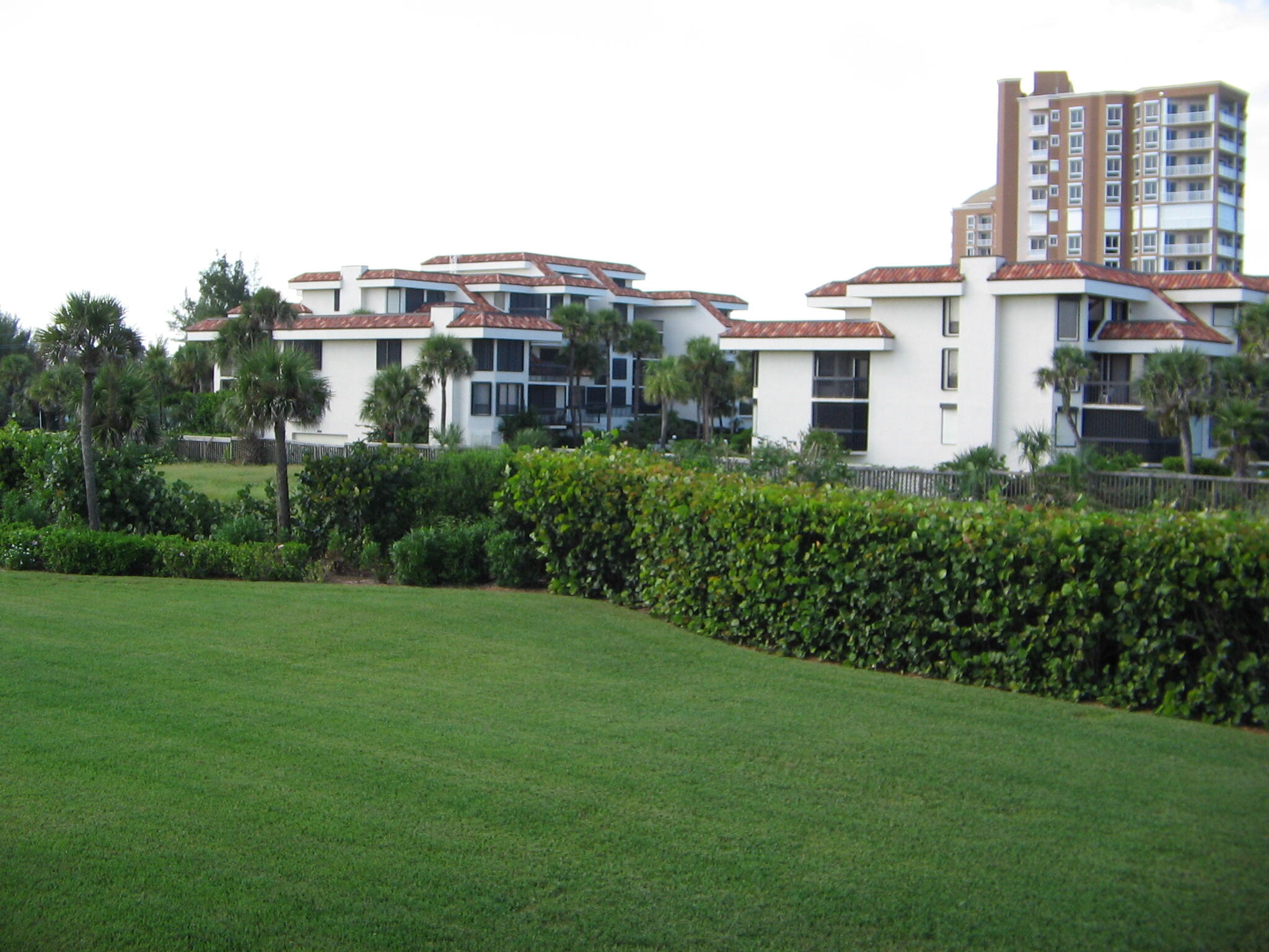 4002 North Hwy A1A Hutchinson Island, FL 34949 - Photo 3 of 3 a view of a white house next to a big yard and large trees