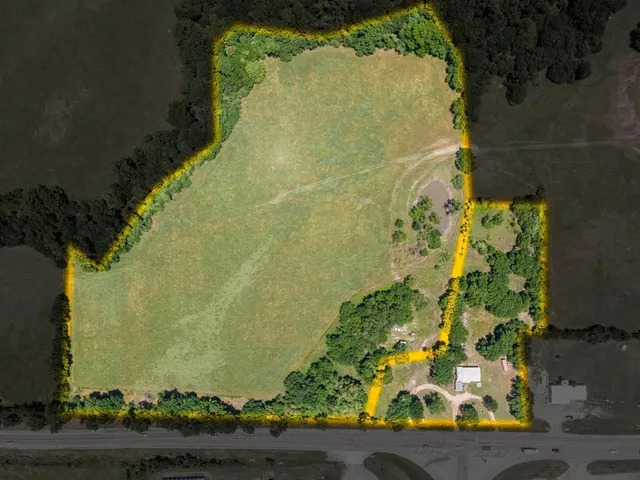 an aerial view of a residential houses with outdoor space