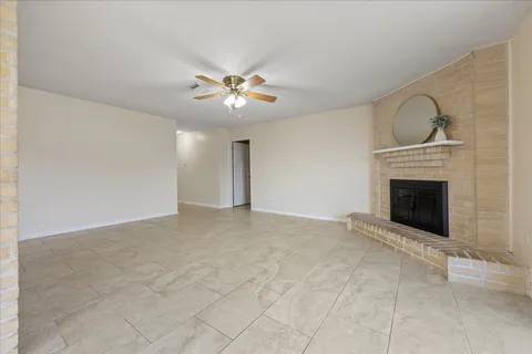 a view of an empty room with a fireplace