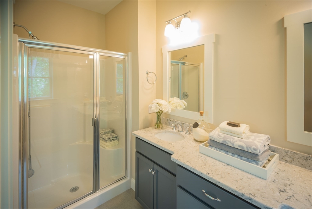 12 Wisteria Road Plymouth, MA 02360 - Photo 11 of 22 a bathroom with a granite countertop sink mirror and double