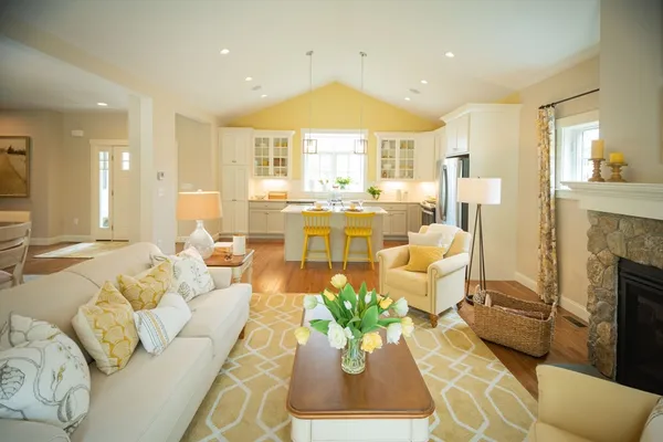 a living room with fireplace furniture and a large window