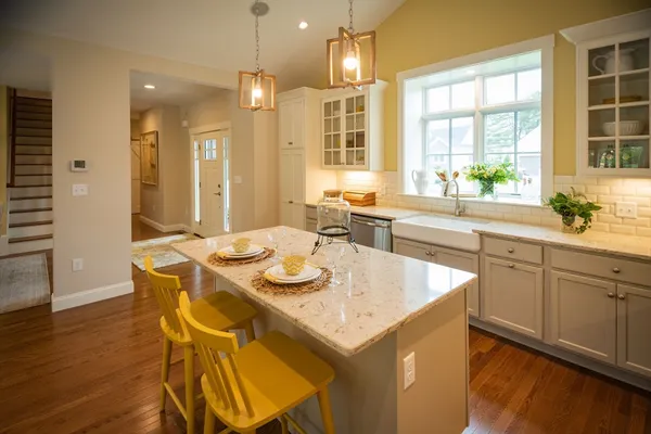 a kitchen with a table chairs sink and cabinets