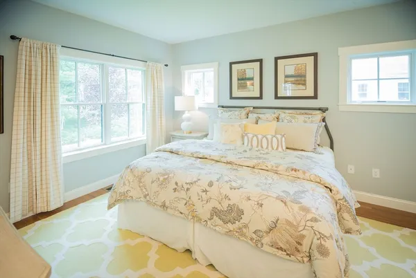 a large bed sitting in a bedroom next to a window