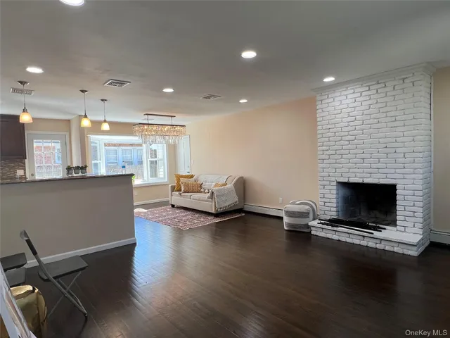 a living room with fireplace furniture and a flat screen tv