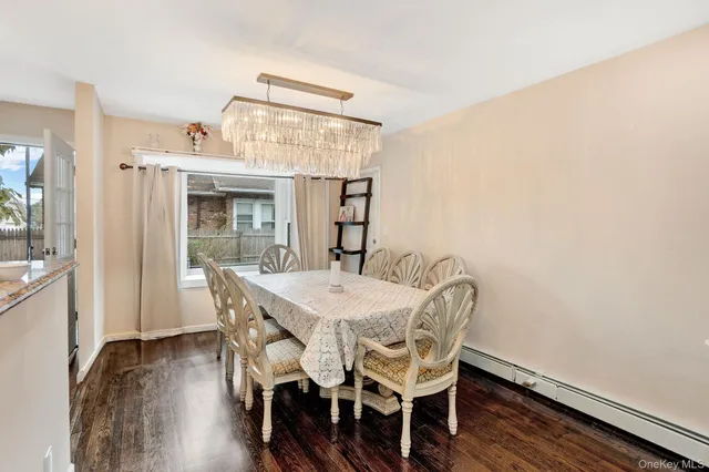 an empty room with wooden floor fireplace and window