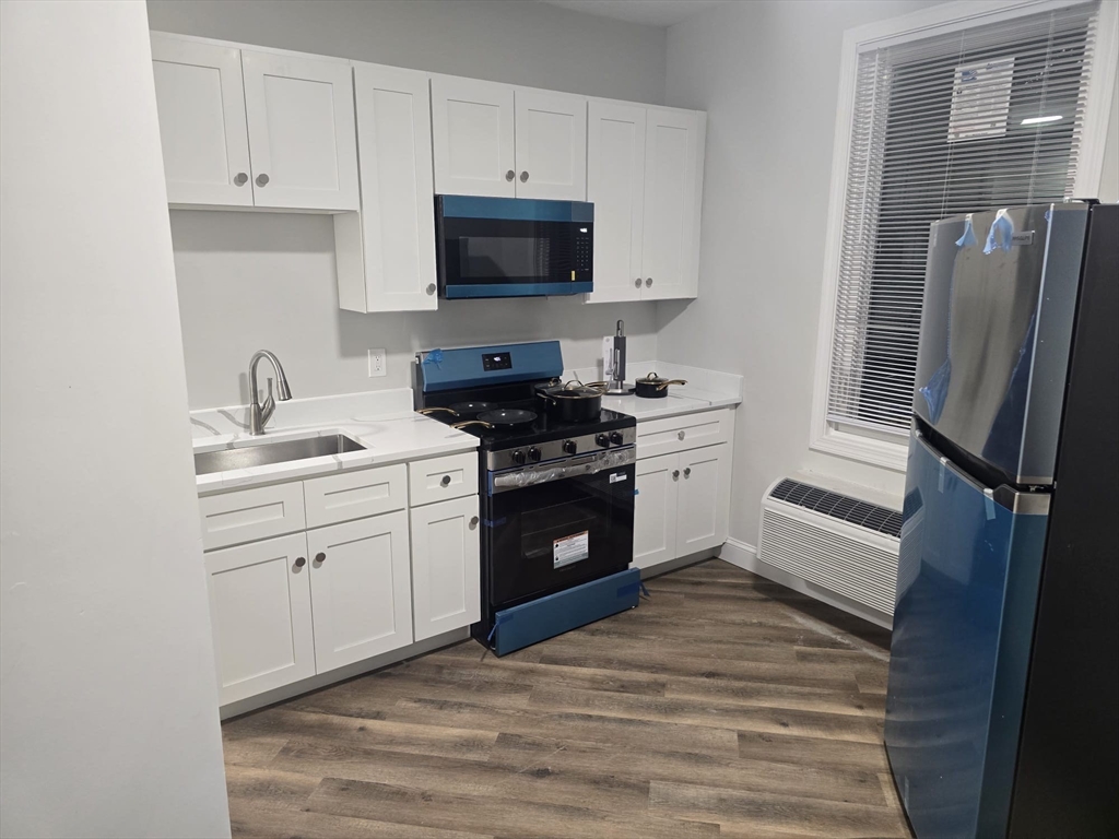 304 Warren Street, Unit 3L Boston, MA 02119 - Photo 2 of 9 a kitchen with a refrigerator stove and sink