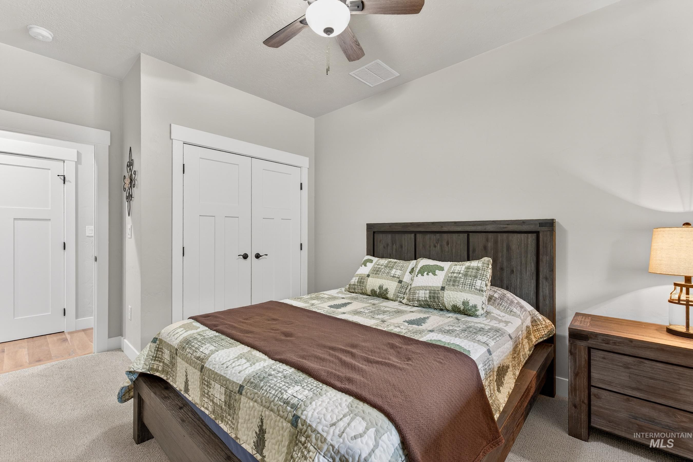 10191 Timberrim Drive Cascade, ID 83611 - Photo 21 of 44 Bedroom featuring a ceiling fan, a closet, and lofted ceiling