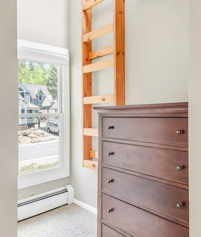 a bathroom with a granite countertop sink and large window