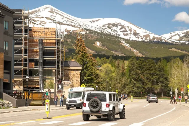 a front view of multi story residential apartment building with a yard