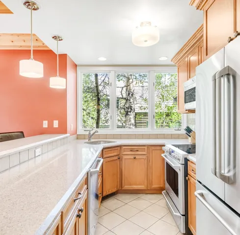 a kitchen with stainless steel appliances a stove sink and microwave