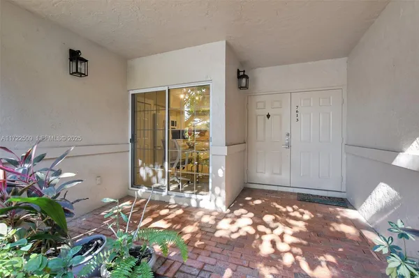 a view of a door and wooden floor