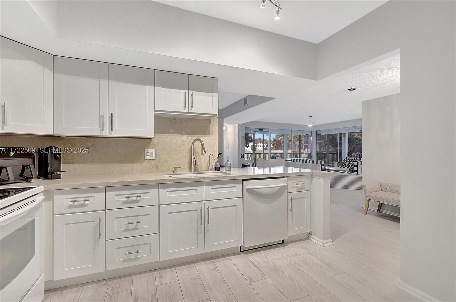 Boca Pointe Boca Raton, FL 33433 - Photo 14 of 32 a kitchen with white cabinets and sink