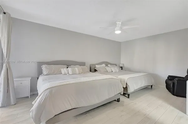 a spacious bedroom with a bed and a table