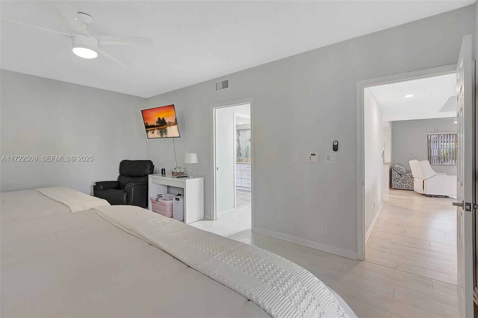 Boca Pointe Boca Raton, FL 33433 - Photo 18 of 32 a bedroom with a bed and a view of en suite bathroom