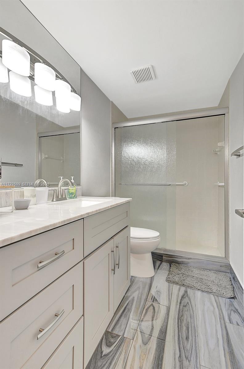 Boca Pointe Boca Raton, FL 33433 - Photo 25 of 32 a bathroom with a sink a toilet and shower