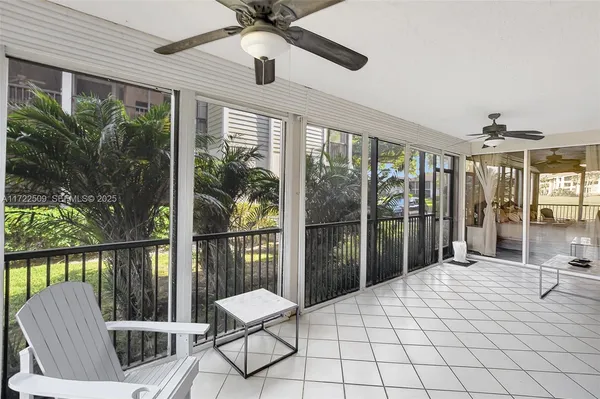 a view of a balcony with chair and a potted plant
