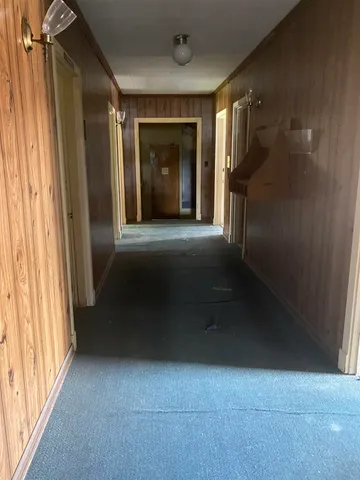 a view of a hallway with wooden shelves