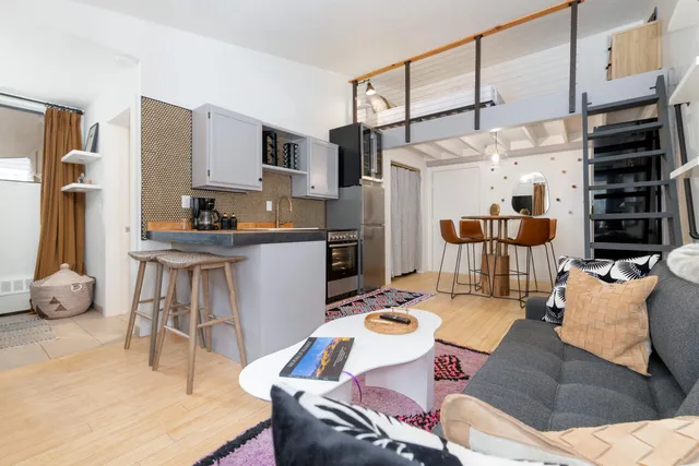 a living room with stainless steel appliances kitchen island granite countertop furniture and a kitchen view