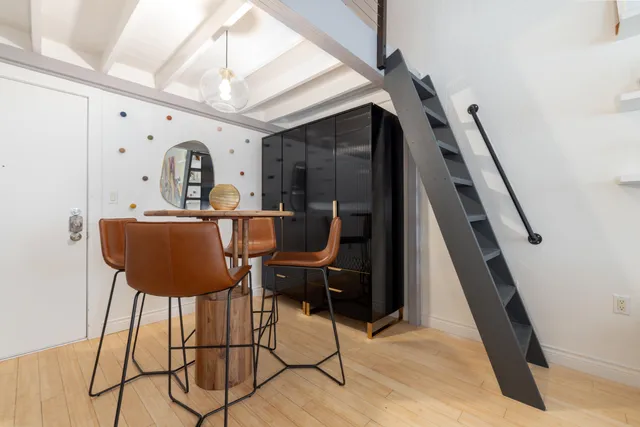 a dining room with furniture and wooden floor