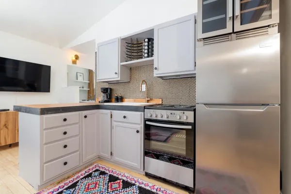 a kitchen with cabinets and stainless steel appliances