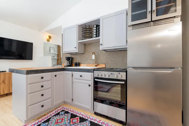 a kitchen with cabinets and stainless steel appliances