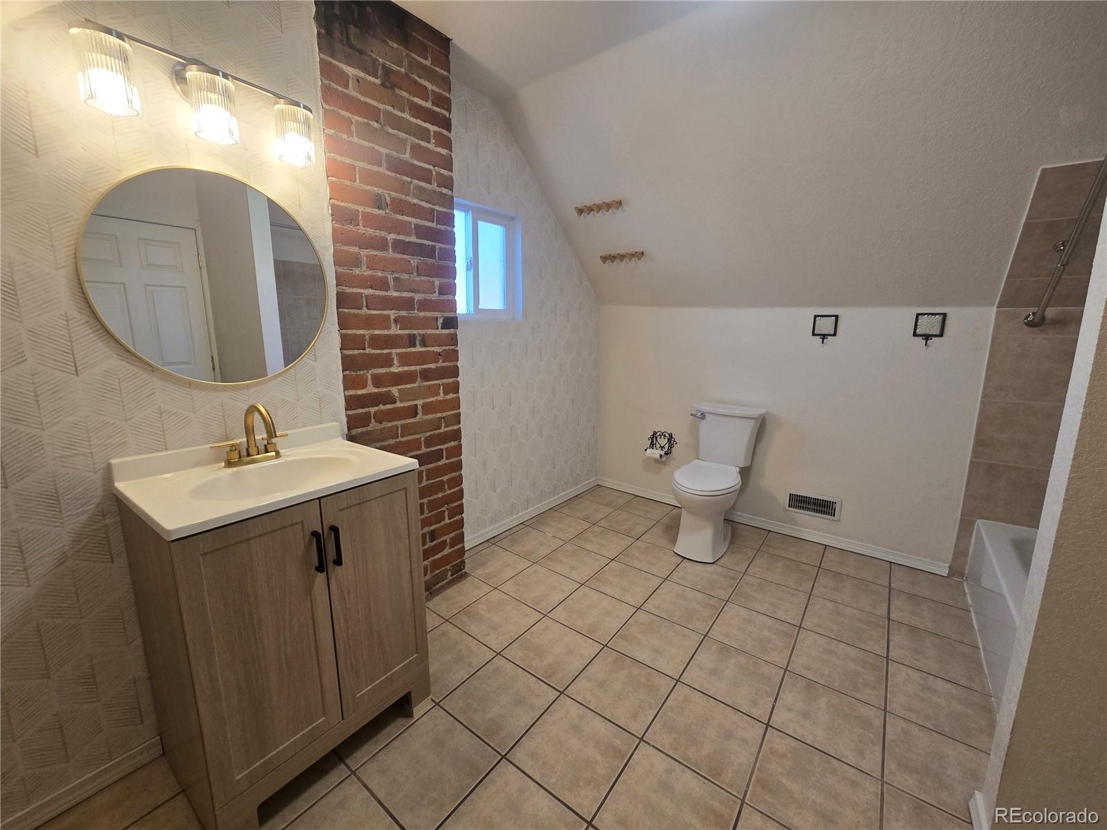 3310 Gilpin Street Denver, CO 80205 - Photo 11 of 20 a bathroom with a sink mirror and toilet