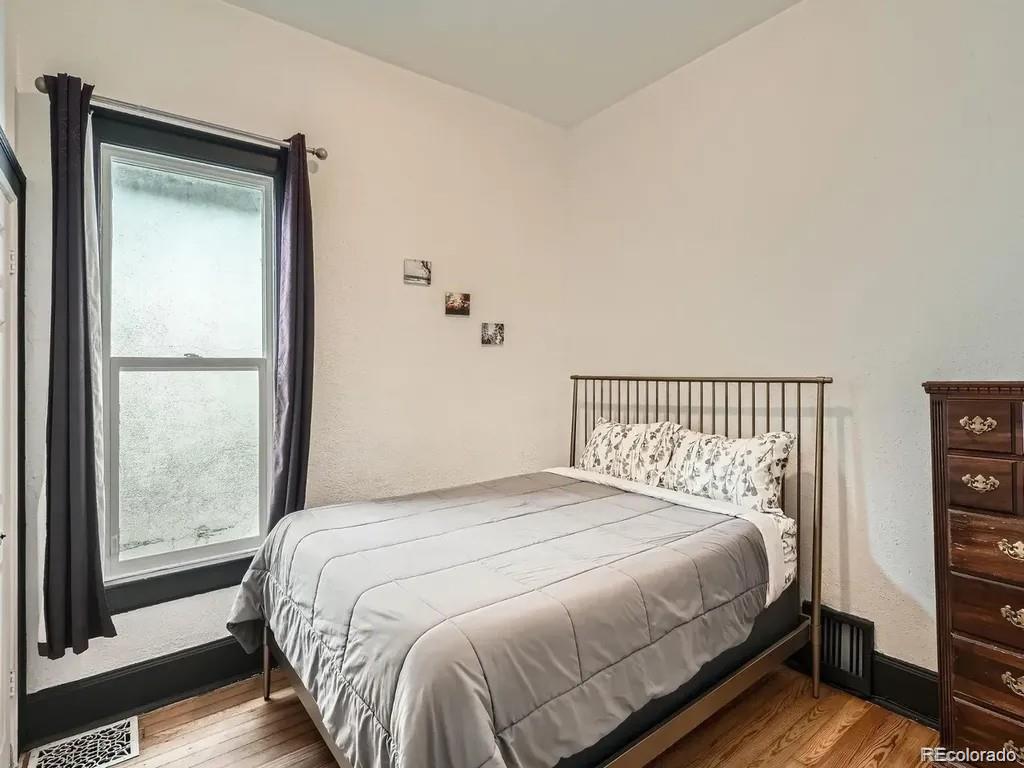 3310 Gilpin Street Denver, CO 80205 - Photo 15 of 20 a bedroom with a bed and a window
