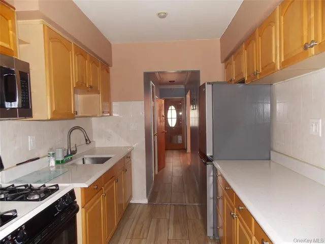 a kitchen with a sink a stove and cabinets