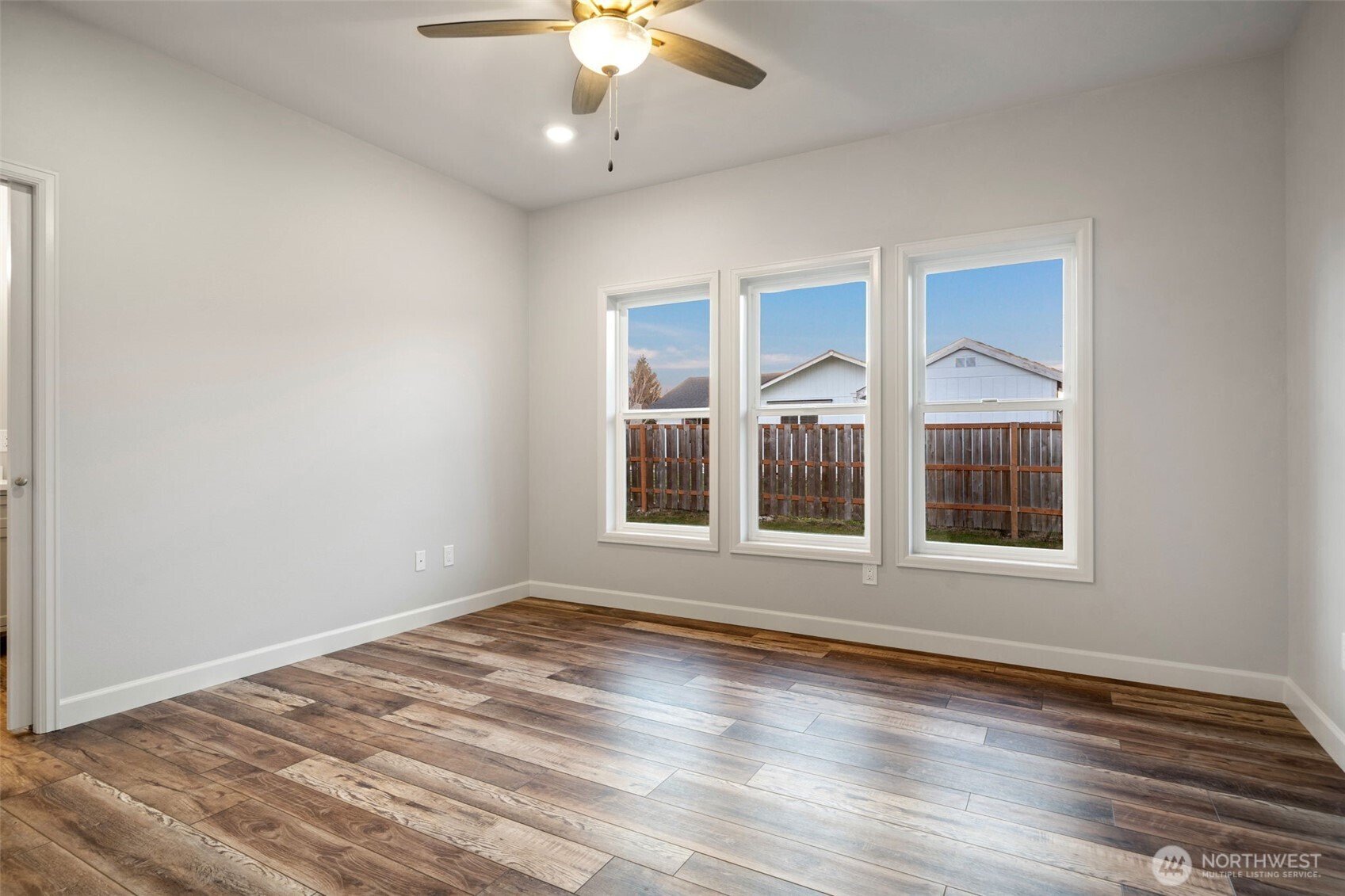 71 Heron Way, Unit A Sequim, WA 98382 - Photo 16 of 31 a view of an empty room with a window and wooden floor