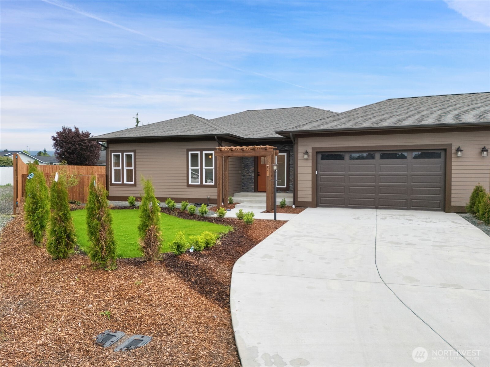 71 Heron Way, Unit B Sequim, WA 98382 - Photo 2 of 33 a house view with a garden space