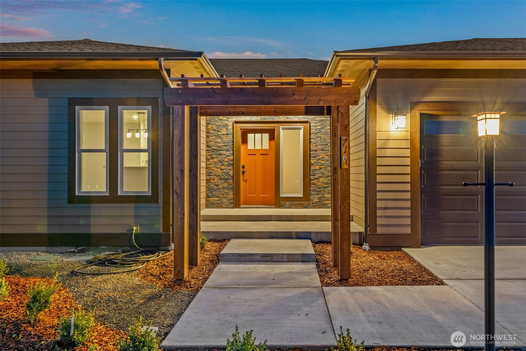 71 Heron Way, Unit A Sequim, WA 98382 - Photo 2 of 31 a view of a brick house with a door and a large window