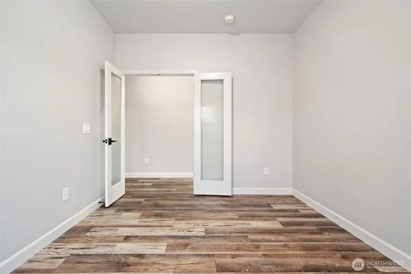 a view of a room with wooden floor