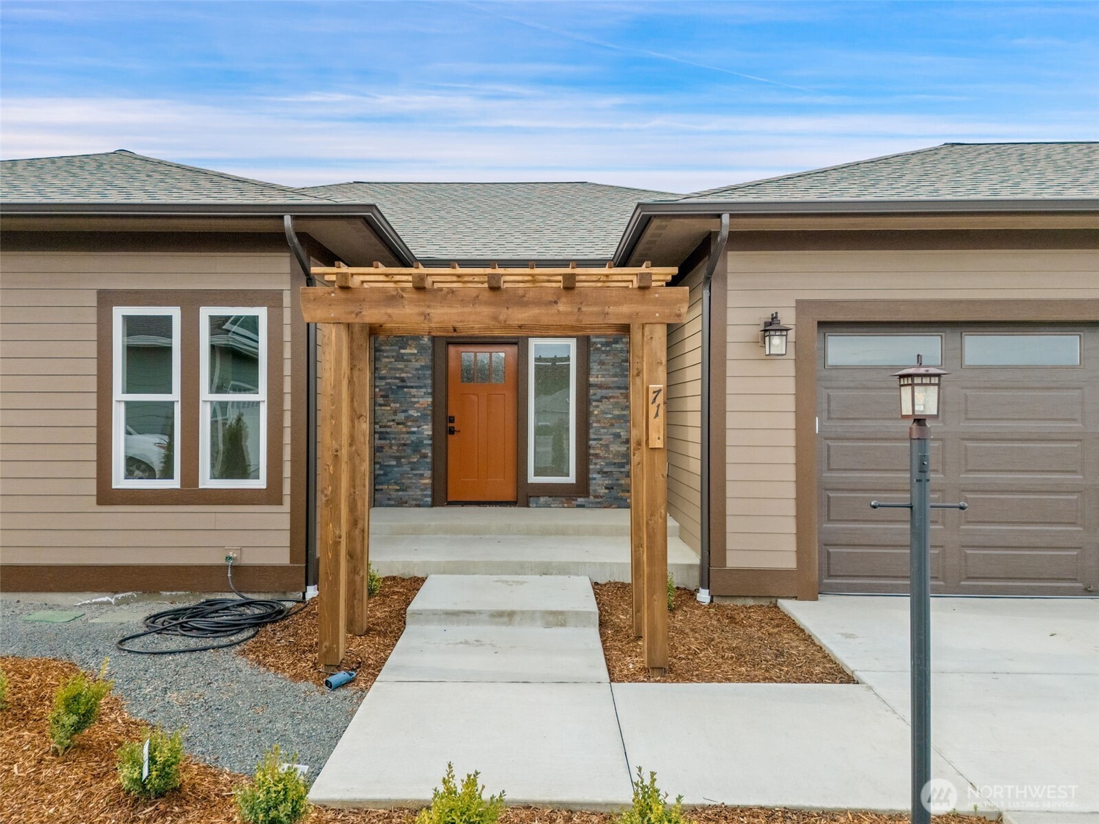 71 Heron Way, Unit B Sequim, WA 98382 - Photo 3 of 33 a front view of a house with a window