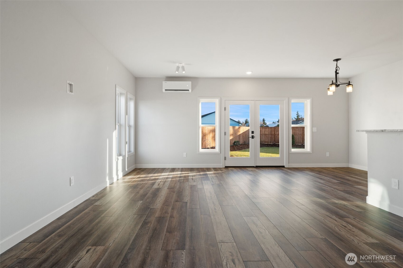 71 Heron Way, Unit A Sequim, WA 98382 - Photo 5 of 31 a view of an empty room with window and wooden floor