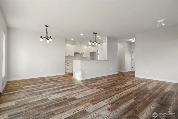 a view of a kitchen with wooden floor and a sink