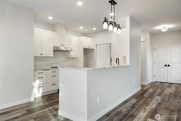 a view of a kitchen with wooden floor