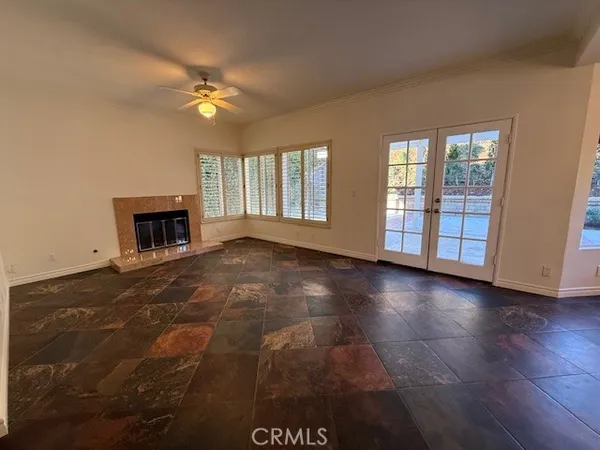 a view of a room with wooden floor and windows