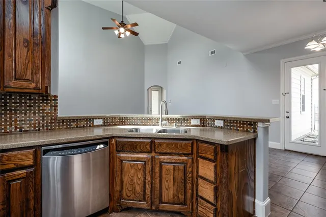 a kitchen with a sink a counter space and cabinets