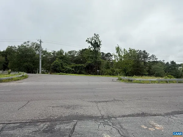 a view of a field with trees in background